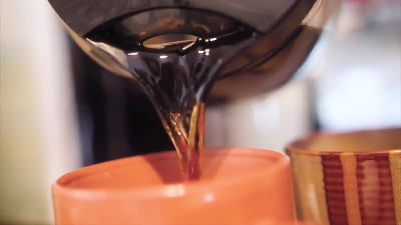 Fresh coffee being poured into a cup