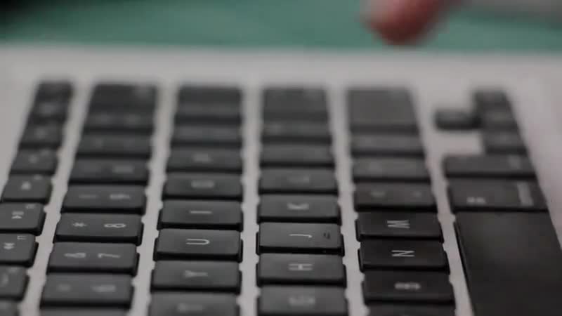 Hands working on a laptop keyboard